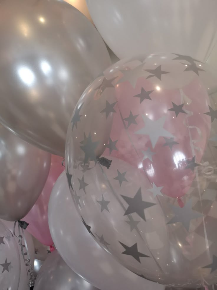 white and silver balloons with stars on them