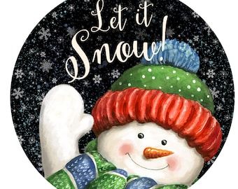 a snowman wearing a red hat and green scarf with the words let it snow