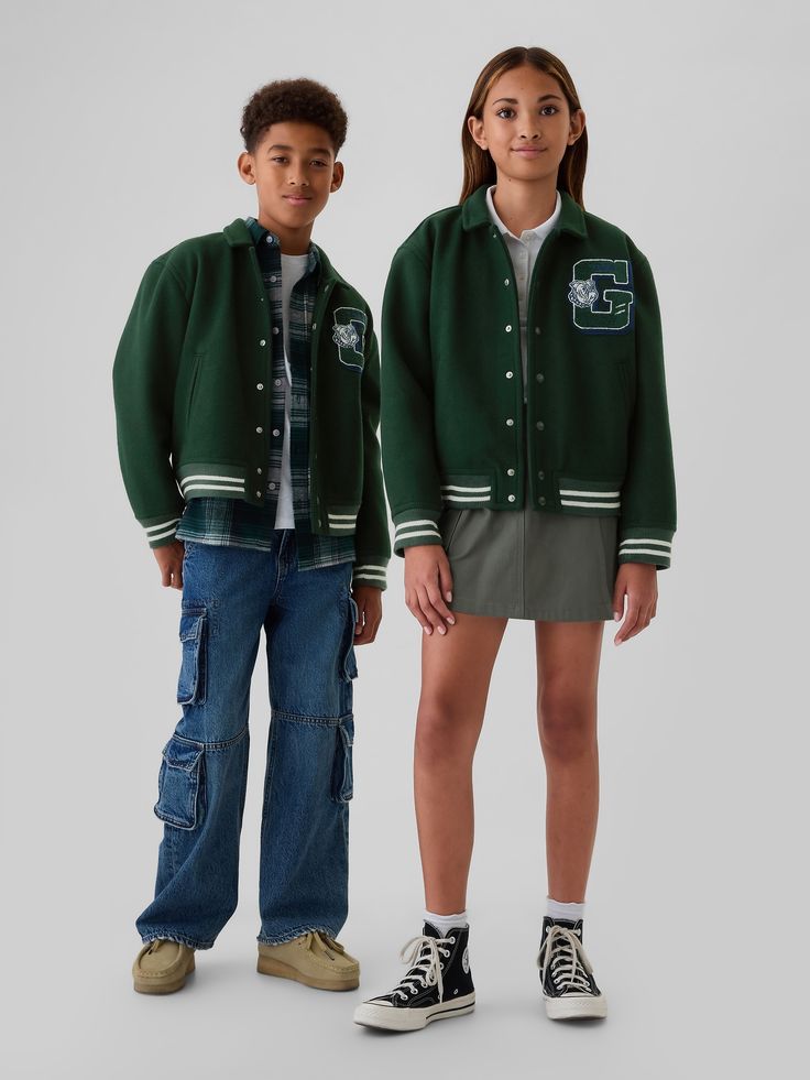 Smooth woven varsity jacket.  Point collar.  Long sleeves.  Snap button front.  Letterman varsity G at front.  Slant pockets.  Banded hem.  Relaxed, easy fit.  Hits at the hip. Green Varsity Jacket, Varsity Jacket Outfit, Kids Inspo, Jumper Short, Toddler Jeans, Varsity Jackets, Jacket Outfit, Japan Style, Boys Fashion