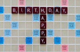 the words happy birthday spelled with scrabble tiles