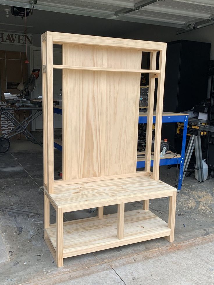 a wooden shelf sitting in the middle of a garage