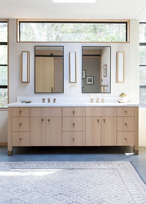 a bathroom with double sinks and mirrors in the middle, along with large windows on both sides