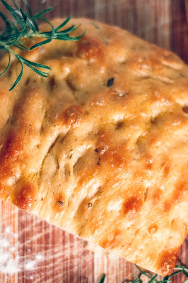 a piece of bread with some green herbs on it