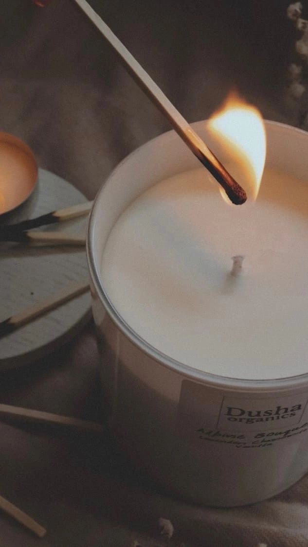 a candle is being lit in a bucket with matches on the table next to it