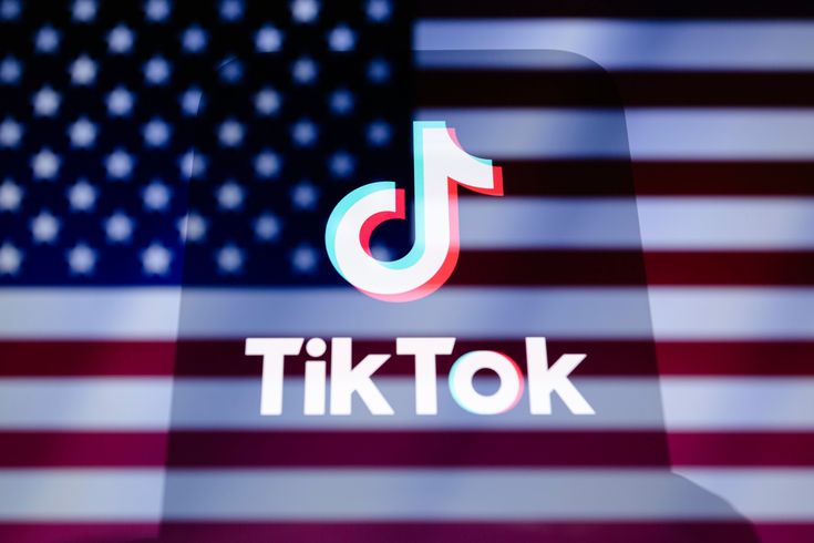 the tiktok logo is seen in front of an american flag