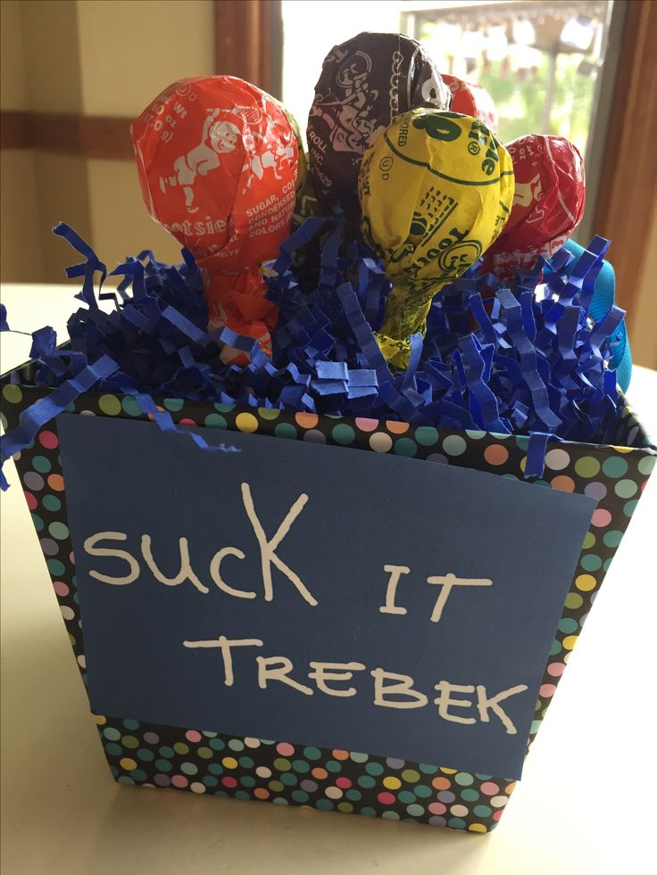 a box filled with assorted candies sitting on top of a table