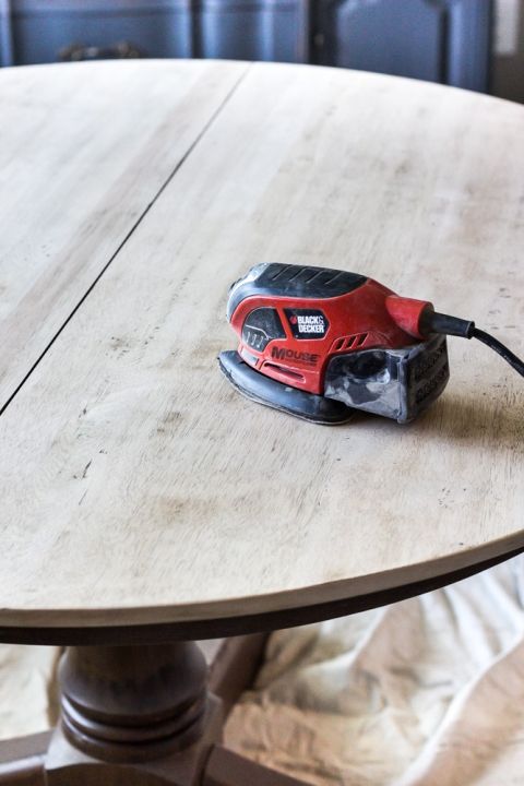 a cordless sanding machine on top of a wooden table