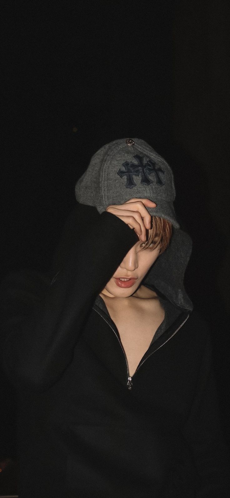 a woman wearing a hoodie covering her face