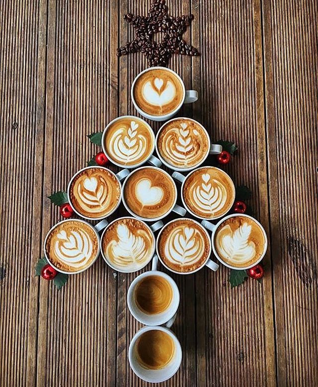 several cups of coffee are arranged in the shape of a christmas tree