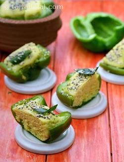 several pieces of food sitting on top of small white plates next to some green peppers