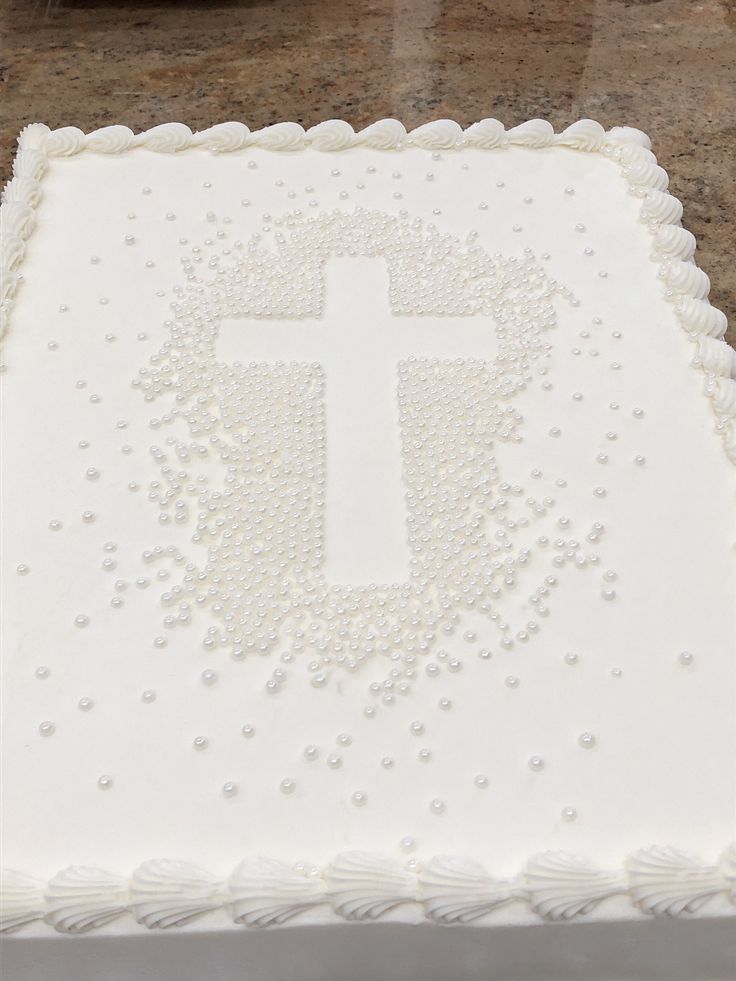 a cake with white frosting and a cross on it