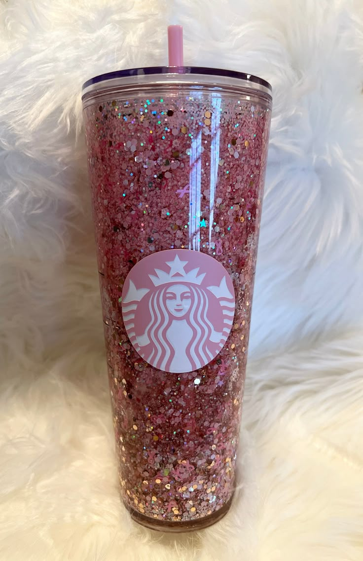 a pink starbucks cup with glitter on it