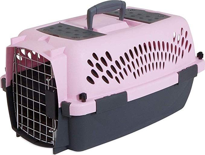 a pink and black dog carrier with its door open