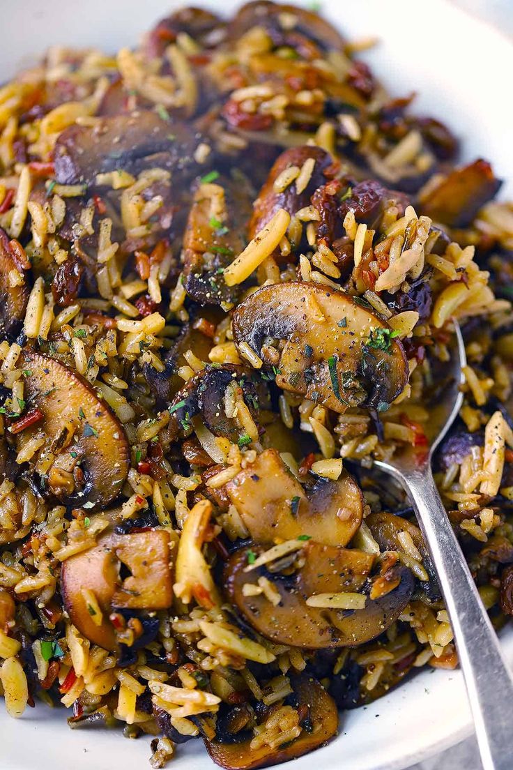 a white plate topped with rice and mushrooms