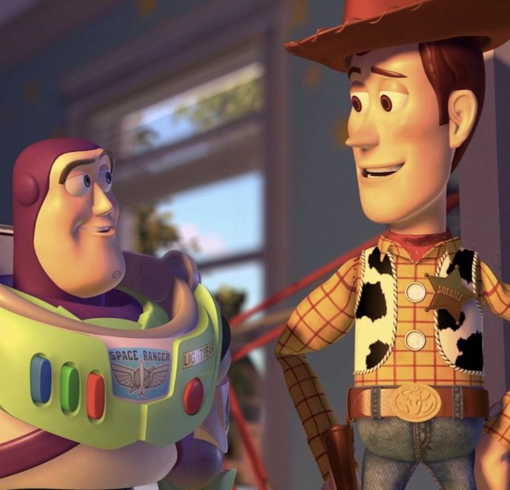 two toy story characters standing next to each other in front of a storefront window