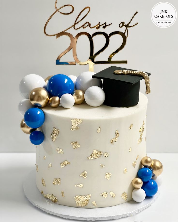 a graduation cake with balloons and a hat on top that says class of 2012 in gold lettering