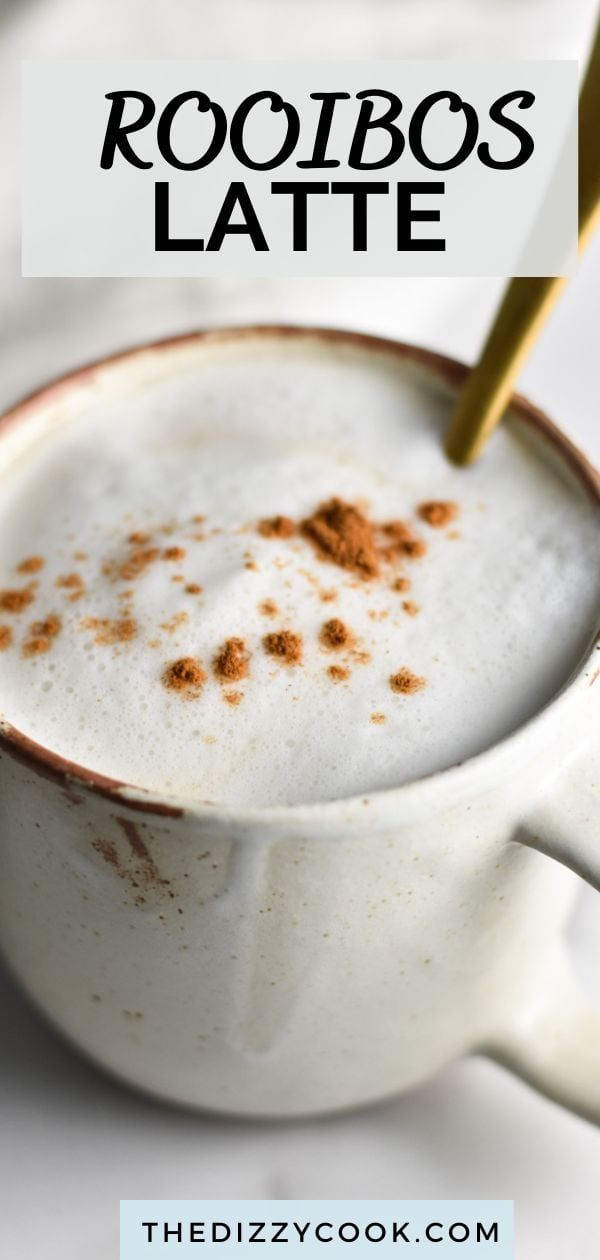 a white cup filled with hot chocolate and topped with cinnamon sprinkled on top