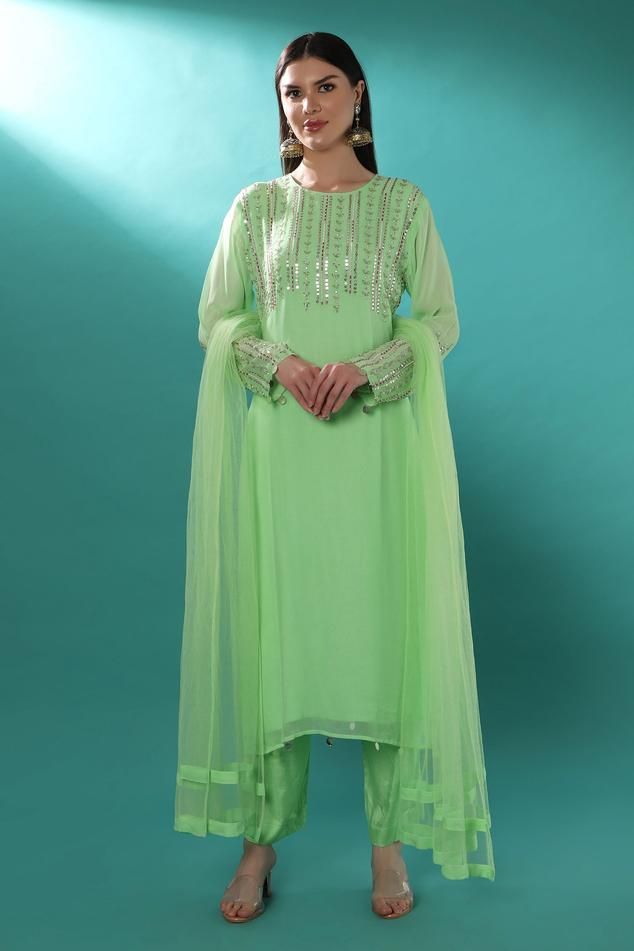 Mint green kurta with sequin, cutbeads, and metallic thread embroidery in linear pattern. Paired with staright pant and net dupatta.
Components: 3
Pattern: Embroidered
Neckline: Round
Sleeve Type: Long
Fabric: Kurta: Georgette, Pant: Shantoon, Dupatta: Net
Color: Green
Other Details: 
Attached lining
Weight: Approx 1 kg
Closure:
Pant: Zip, Hook and Eye
Length:
Kurta: 50 inches
Pant: 38 inches
Occasion: Mehendi and Haldi - Aza Fashions Linear Pattern, Net Dupatta, Embroidered Neckline, Kurta With Pants, Metallic Thread, Straight Pants, Aza Fashion, Pants Set, Types Of Sleeves