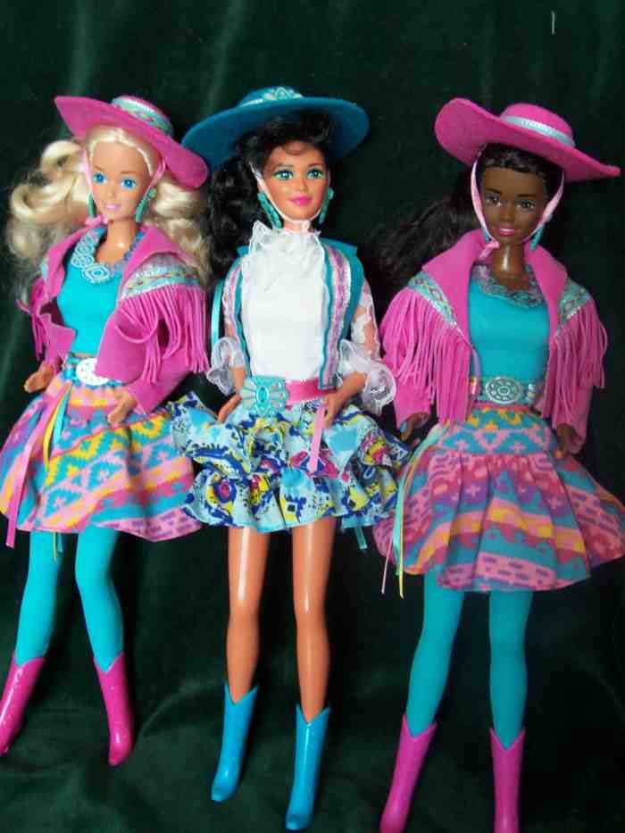 three barbie dolls dressed in colorful outfits and hats