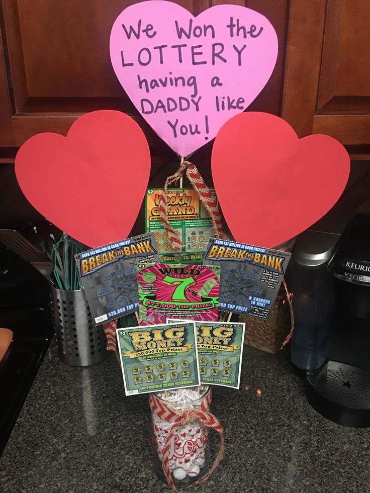 two heart shaped balloons sitting on top of a counter next to a sign that says we won the lottery having & daddy like you