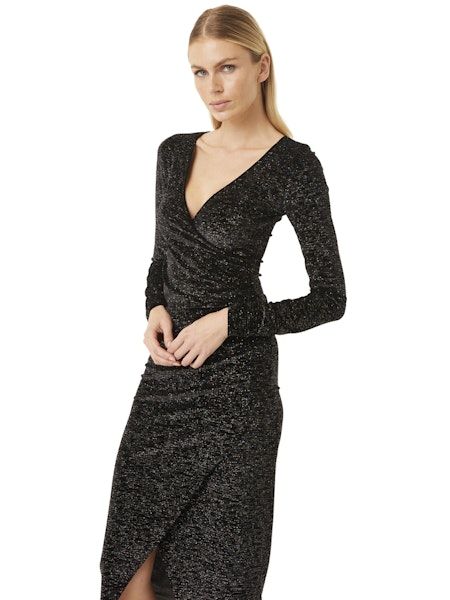 Product Description Look radiant in this beautiful MISA Los Angeles Setarah Dress. Embellished with elegant sparkle, this fabulous piece will make you stand out in any room. Be the life of the party with this stunning and eye-catching dress! Setarah is a metallic knit faux-wrap dress. This body conscious silhouette features a vented skirt, v neckline and long sleeves. A hidden zip closure The hem falls just below the knee This glittering dress is sure to stun this holiday season and beyond *Leave a little sparkle wherever you go...due to the nature of this fabric, shedding glitter is normal. Style: PGDL8701 Color: Astral Dusted Fabric and Care ﻿﻿95% Polyester/5% Spandex Dry clean Sparkling Fitted V-neck Evening Dress, Fitted Shimmer Dress For Festive Season, Fitted V-neck Shimmer Sequin Dress, Fitted V-neck Sequin Dress With Shimmer, Elegant Shimmer V-neck Evening Dress, Elegant Festive Dresses With Shimmer, Elegant Sequin Glitter Dress For Gala, Elegant Shimmer Sequin Dress For Holiday Party, Elegant Holiday Sequin Dress With Shimmer