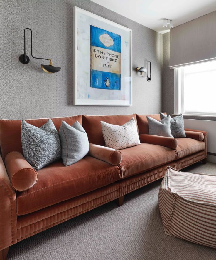 a living room filled with lots of furniture and decor on top of carpeted flooring