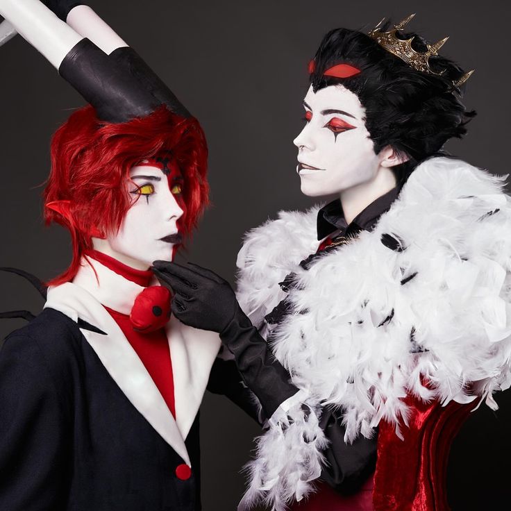 two people dressed up in costumes and make - up, one with red hair and the other white