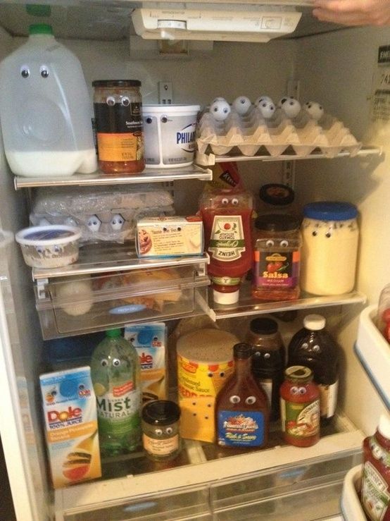 an open refrigerator filled with lots of food and condiments on the bottom shelf