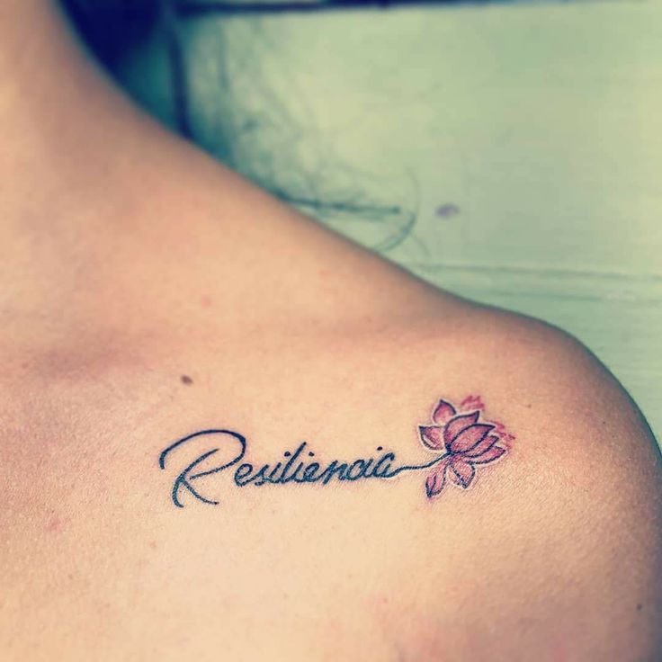 a woman with a tattoo on her shoulder that reads resiline and has a flower