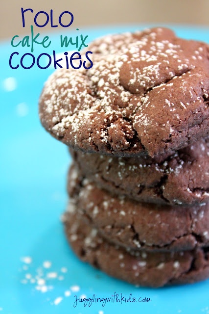 three chocolate cookies stacked on top of each other with powdered sugar in the middle