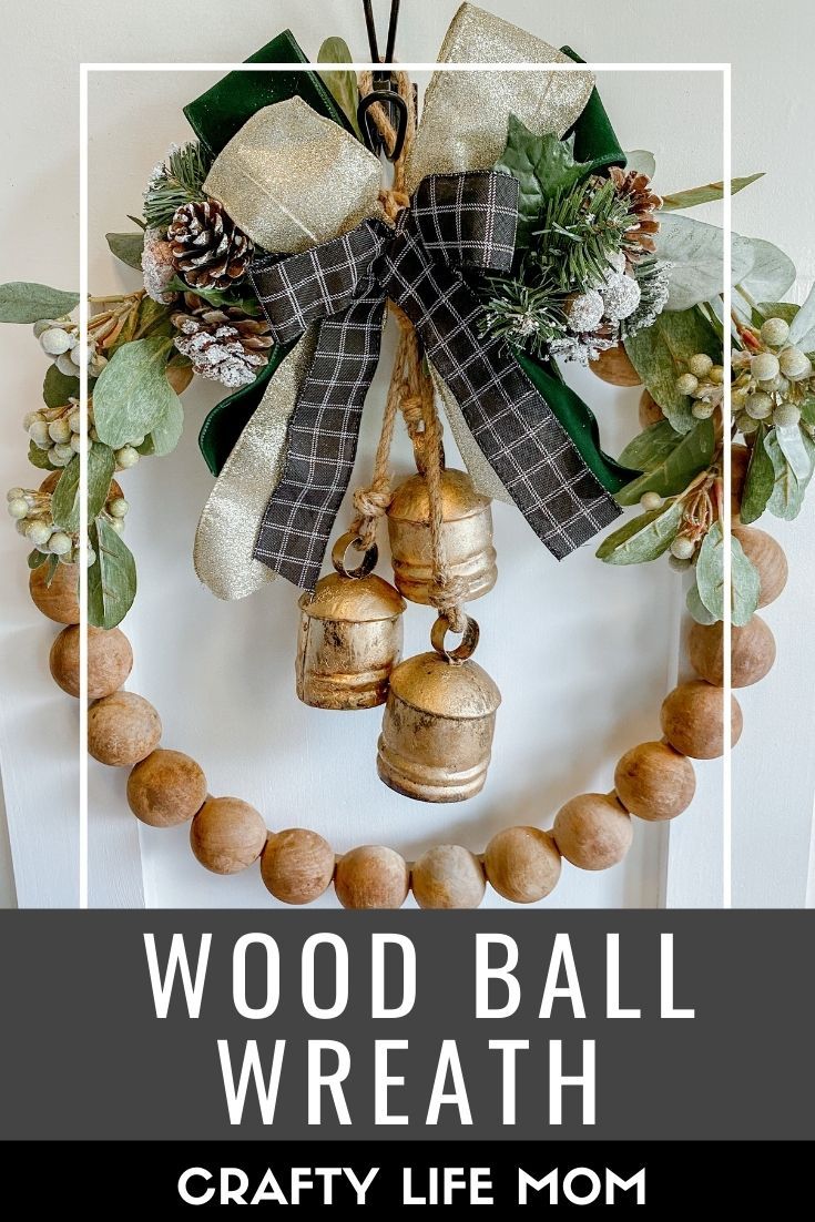 a wreath with bells and greenery on it that says wood ball wreath crafty life mom