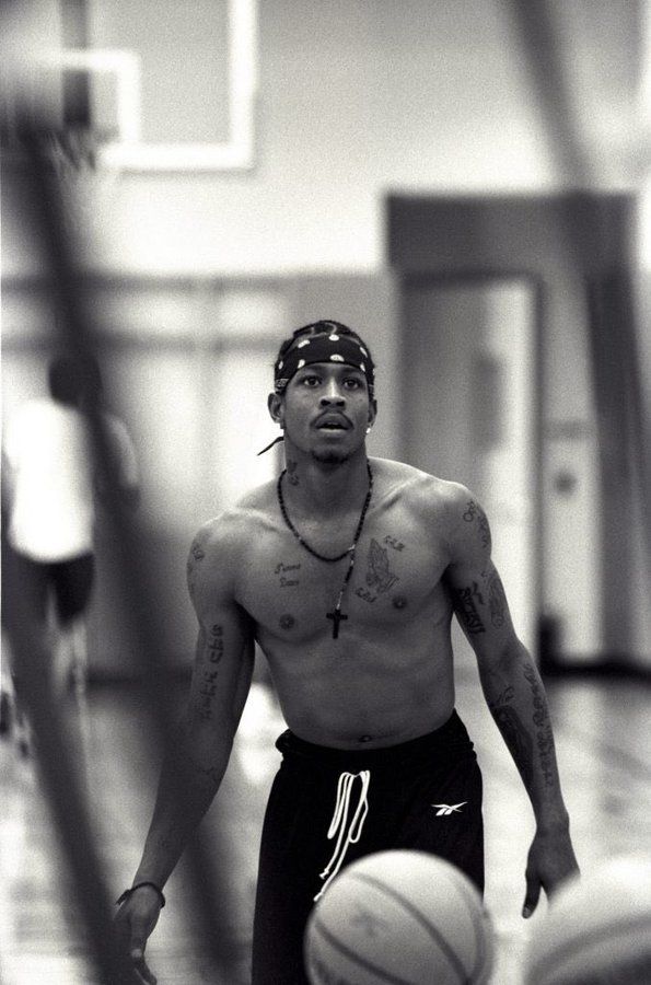 a shirtless man holding a basketball in his hand