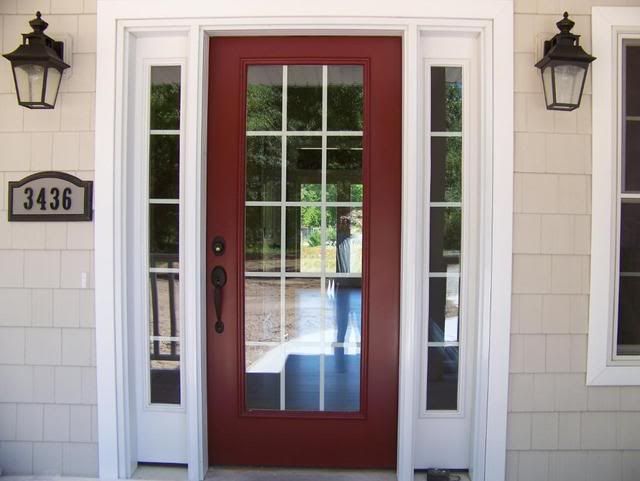 a red front door with two sidelights