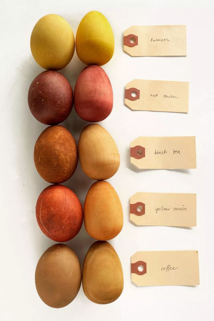 an assortment of different colored eggs with price tags on the side and labels attached to them