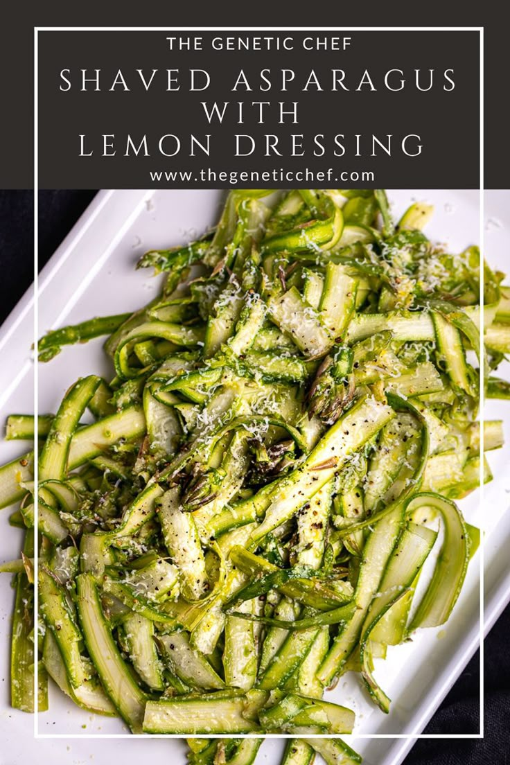 a white plate topped with shaved asparagus and lemon dressing