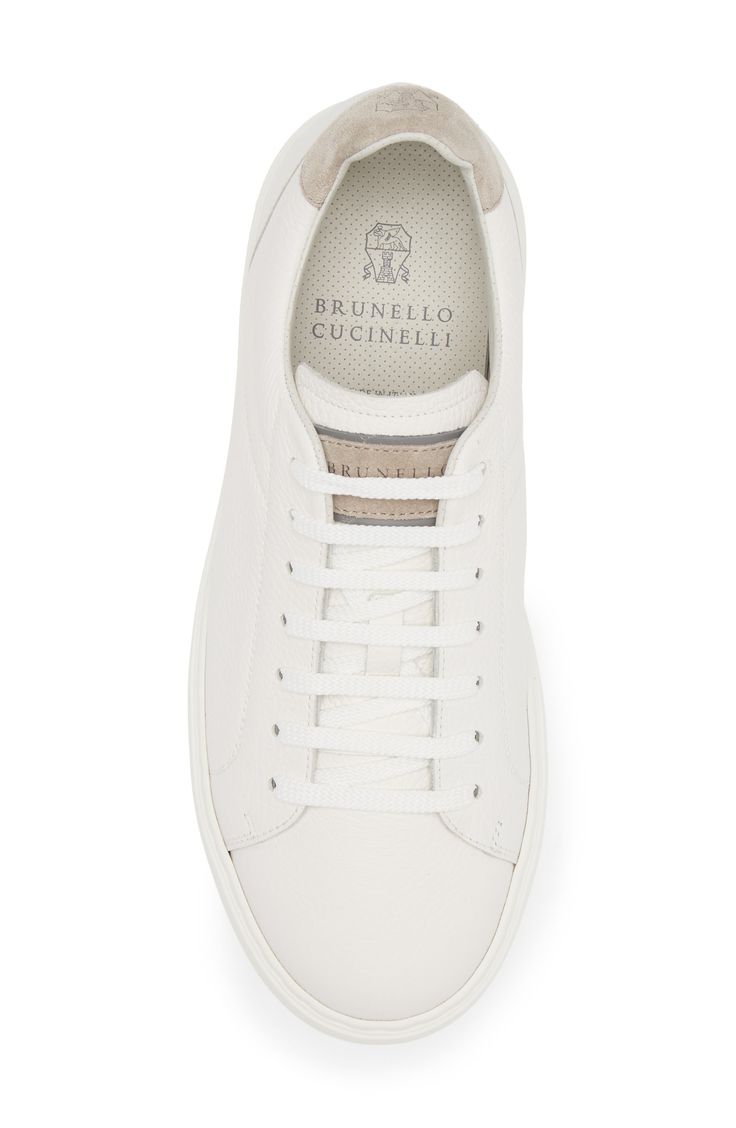 A lightweight rubber sole offers cushiony comfort as well as color contrast to the grained calfskin-leather upper of this refined Italian-crafted sneaker. Lace-up style Leather upper and lining/rubber sole Made in Italy Designer Shoes White Shoes Men, Brunello Cucinelli Men, Perforated Leather, Sneakers Blue, Suede Sneakers, Color Contrast, Brunello Cucinelli, White Shoes, Up Styles