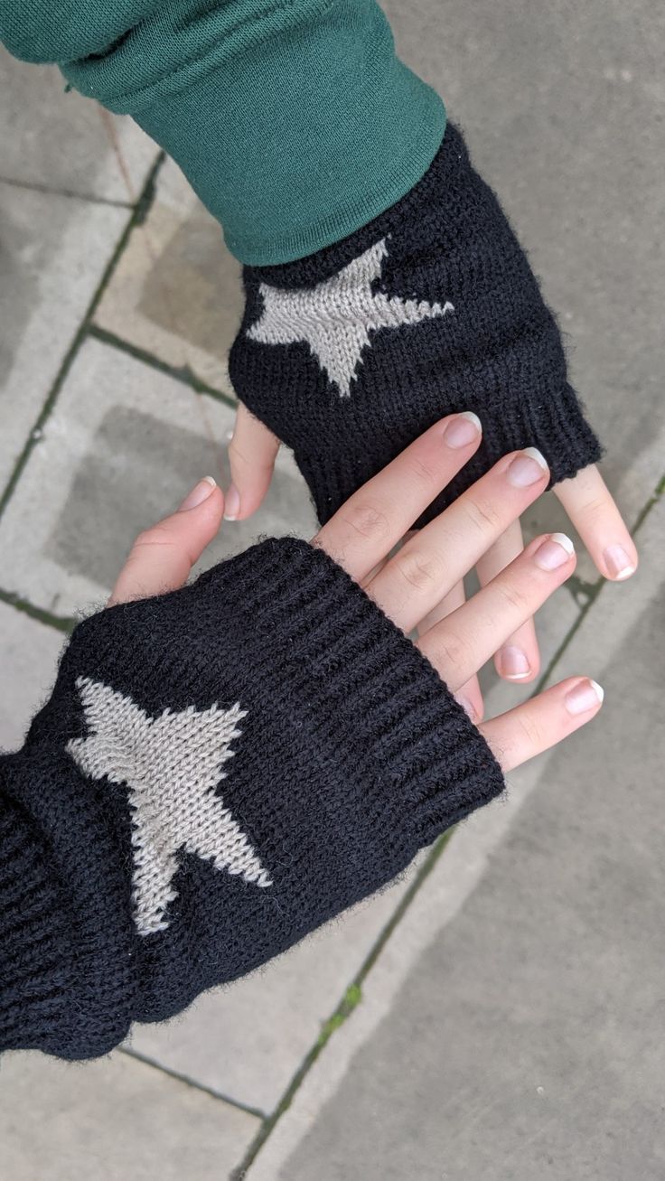 a woman's hand wearing an arm warmer with stars on it