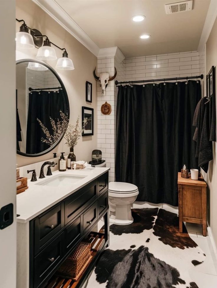 a white toilet sitting next to a black and white rug on top of a bathroom floor