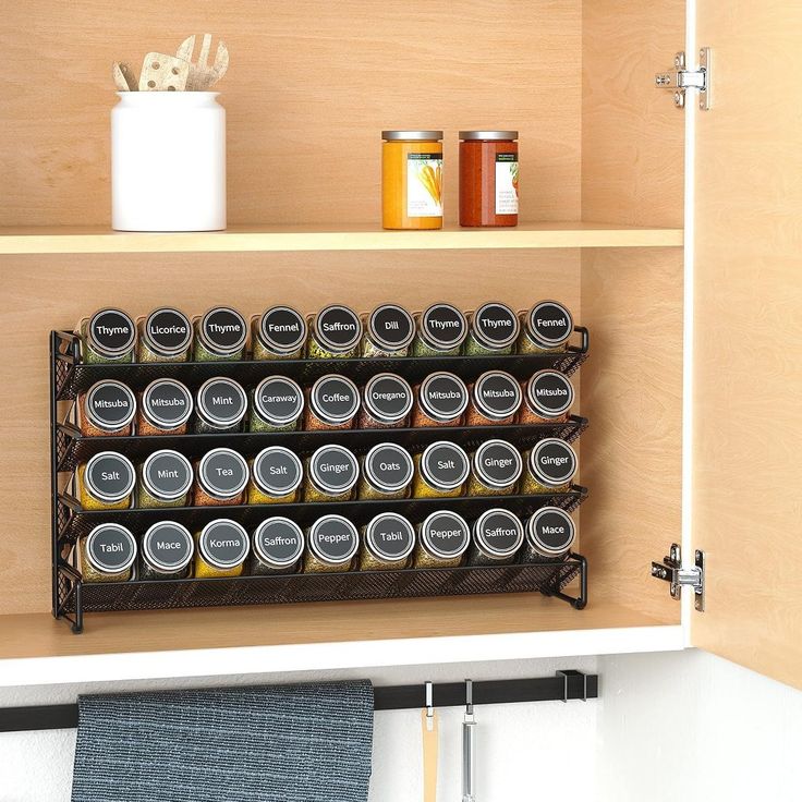 an organized spice rack in the corner of a kitchen