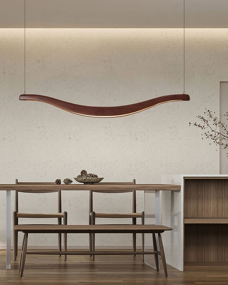 a dining room table with two benches and a long wooden shelf above it, in front of a white wall