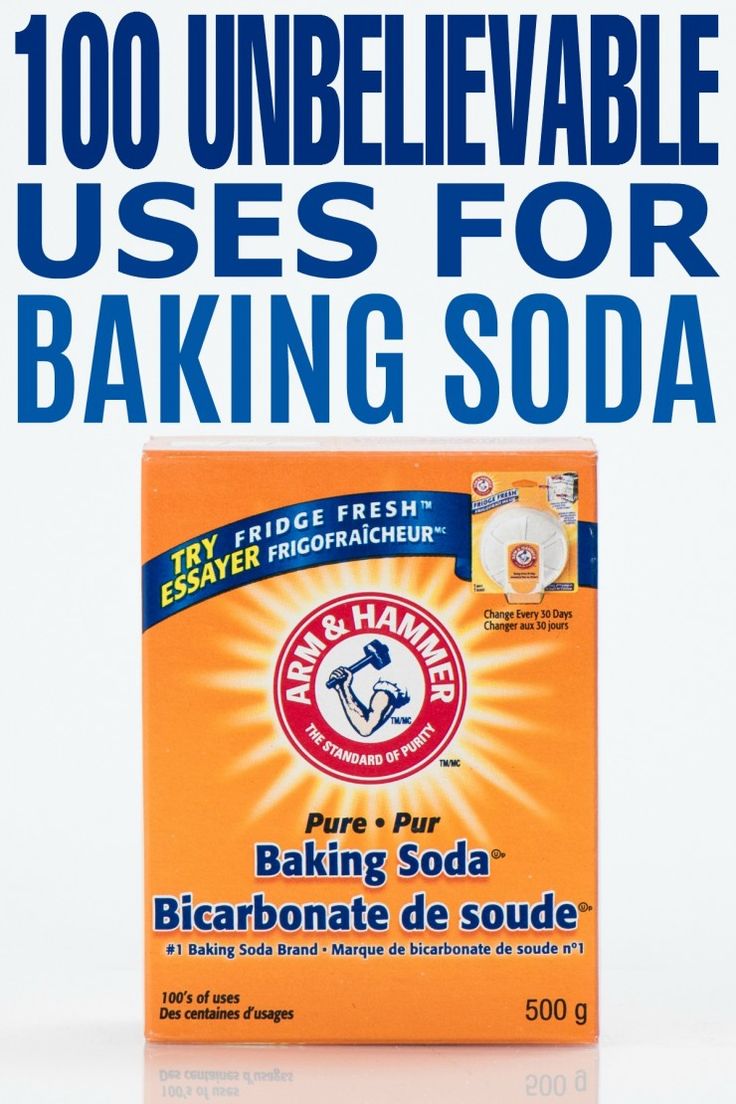 a box of baking soda sitting on top of a white table next to an advertisement for baking soda