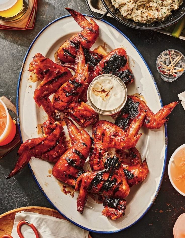 chicken wings on a plate with dipping sauce