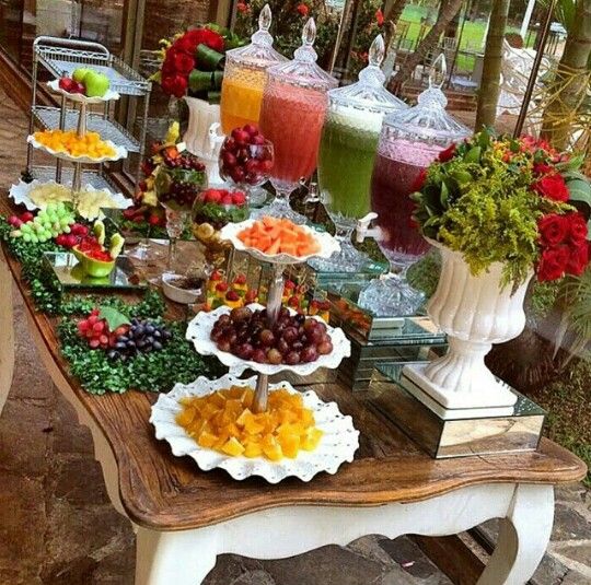 a table topped with lots of different types of fruit and veggies on plates