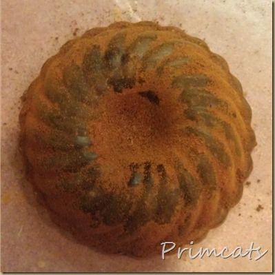 a bundt cake sitting on top of a white counter covered in brown and green stuff