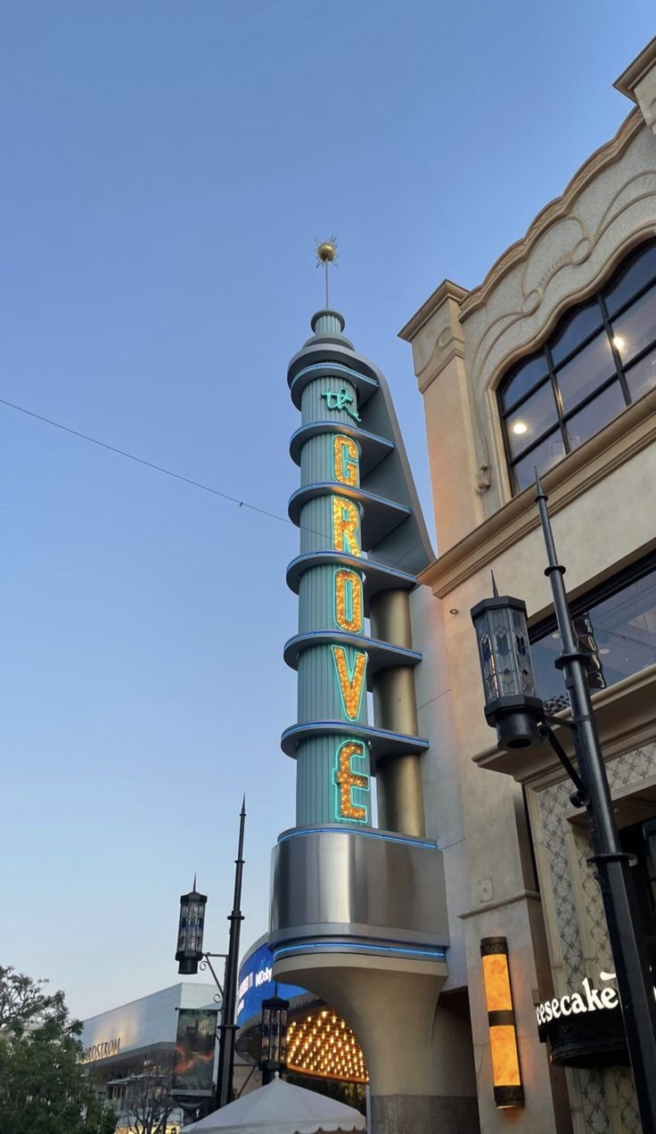 a tall tower with the word love spelled on it's side in front of a building