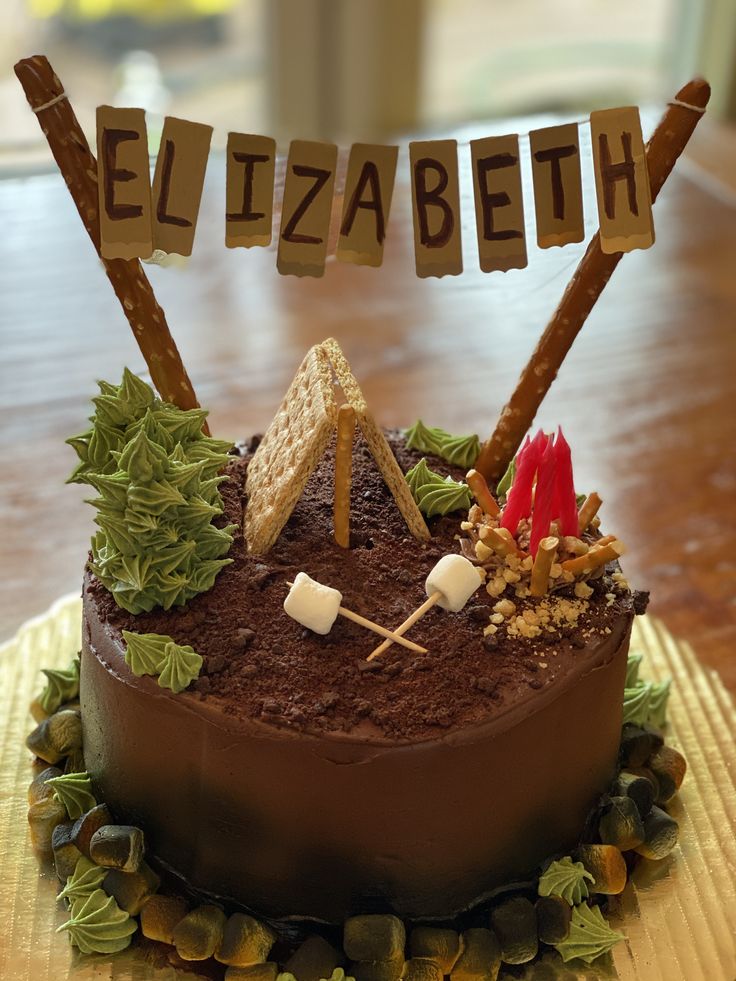 a cake that is sitting on top of a table with the word elizabeth spelled out