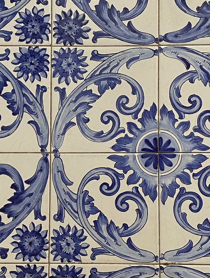 a blue and white tile with an intricate design