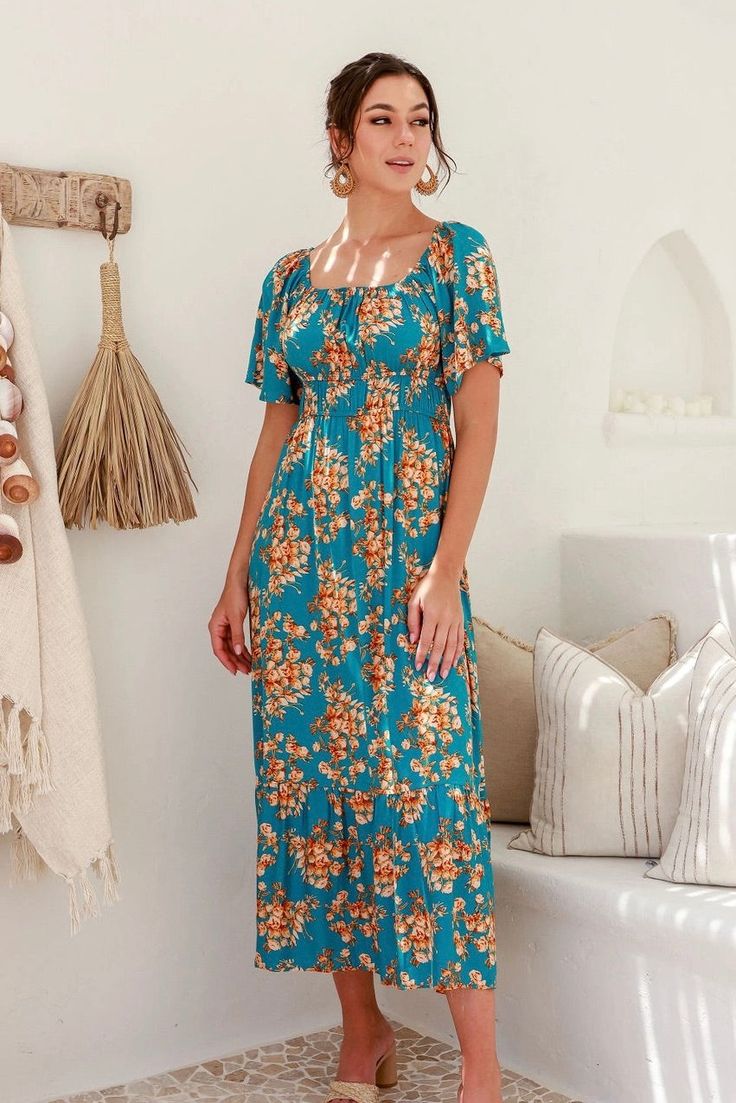 A fun floral maxi dress with a gorgeous teal color to make the look pop. This dress has short sleeves with an elastic neckline, allowing you to style the dress on or off the shoulders. There are two elastic lines below the chest for shaping. The rest of the dress is loose, flowy, and ready for a lunch date with friends. Model is 5'10" and wearing her true size Small. Small: Bust 14", Length 52" 100% Rayon Casual Turquoise Maxi Dress For Spring, Short Sleeve Dress With Elastic Neckline For Garden Party, Turquoise Short Sleeve Maxi Dress For Beach, Turquoise Short Sleeve Maxi Dress For The Beach, Casual Turquoise Maxi Dress With Floral Print, Spring Maxi Dress With Elastic Neckline And Short Sleeves, Spring Maxi Dress With Short Sleeves And Elastic Neckline, Casual Maxi Dress With Elastic Neckline For Brunch, Beach Maxi Dress With Smocked Bodice And Short Sleeves