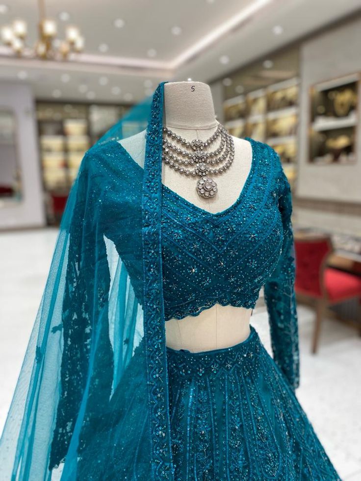 This Teal Bridal Lehenga BL-099 offers a stunning and elegant look for any bride's special day. Made with high-quality materials, it provides comfort and durability. The rich teal color adds a regal touch while the intricate design showcases traditional craftsmanship. Perfect for capturing unforgettable moments. Fabric: Net with Satin Silk Lining! WASH CARE INSTRUCTIONS - Please Dry clean only when it is applicable! Ready to Ship! Elegant Turquoise Festive Set, Elegant Turquoise Set With Dupatta, Ceremony Gown With Dupatta Fitted, Fitted Gown With Dupatta For Ceremony, Ceremony Fitted Gown With Dupatta, Fitted Ceremony Gown With Dupatta, Ceremony Dupatta Gown, Elegant Wedding Dress With Tilla Embroidery, Turquoise Saree With Zari Work For Wedding