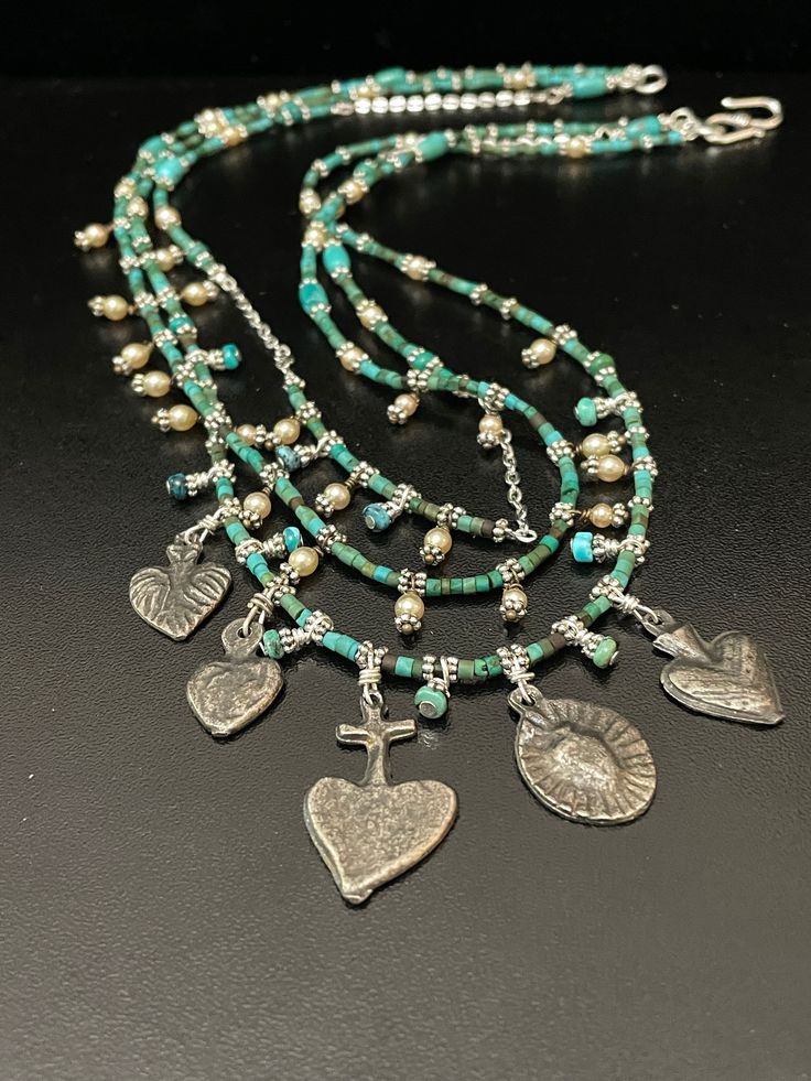 Milagros Treasure Necklace, Turquoise Heishi Dash of Pearls, and Silver.  In Spanish means "miracle" or "surprise" and people in the past and present use them as symbols to wish others good luck, good health, and hope for the future. Initially,  Three Strands, Cluster of Surprise. Three Strand Necklace Length 18" Length 19" Length 20" Weight 30 grams Such a wonderful Treasure, Find your spirit and your style! I have a wonderful collection of goodies quality, hip, classic, traditional. Open studi Treasure Necklace, Three Strand Necklace, Pacific Grove, Hope For The Future, Necklace Turquoise, Jade Necklace, Past And Present, Big Sur, In Spanish